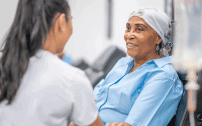 A doctor talking to an adult cancer patient.
