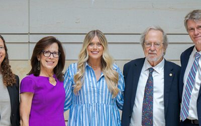 Photo of a group of five people smiling at the camera.