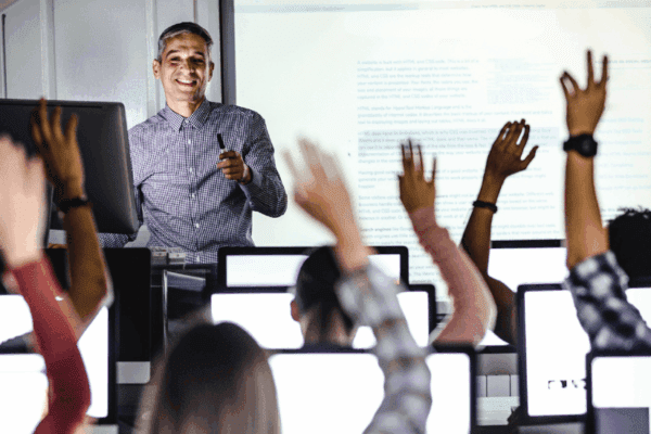 A professor teaching in a computer lab