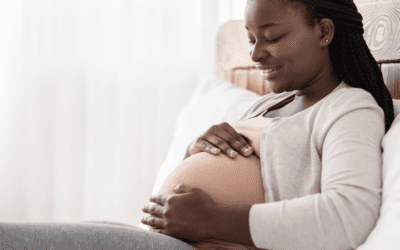 A pregnant woman holding her stomach