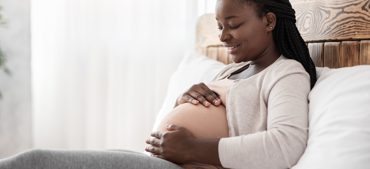 A pregnant woman holding her stomach