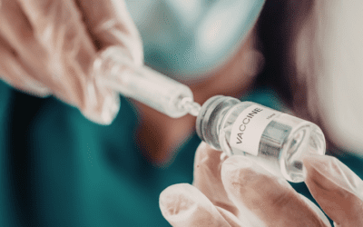 doctor drawing up a dose from a vaccine vial