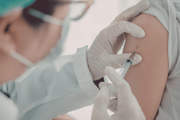 Doctor administering an mRNA vaccine to a patient