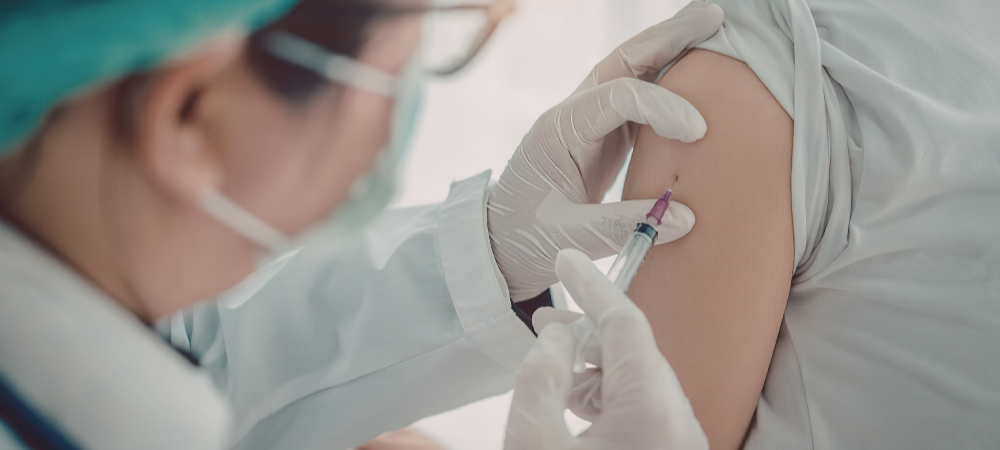 Doctor administering an mRNA vaccine to a patient