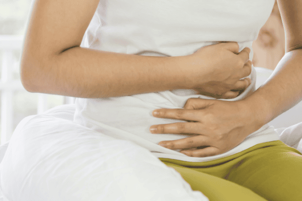 a close up of someone clutching their stomach