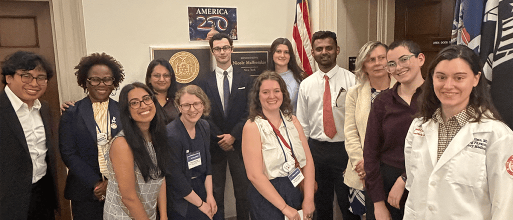 A group of immunologists pose with members of a congressional office