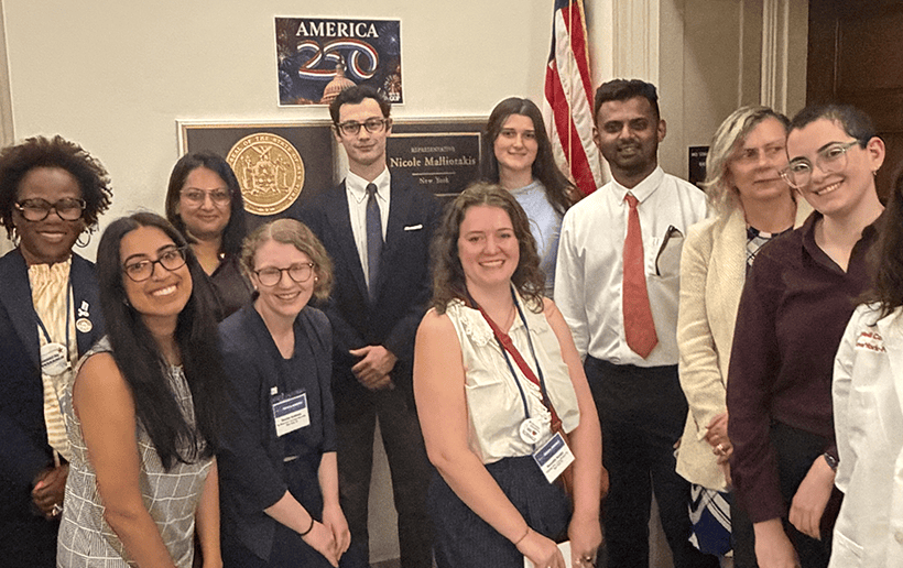 A group of immunologists pose with members of a congressional office