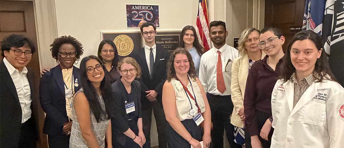A group of immunologists pose with members of a congressional office
